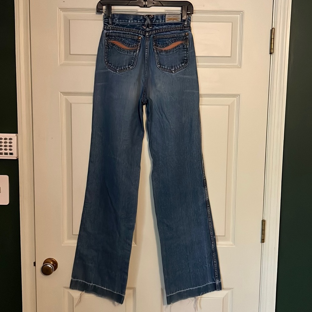 Authentic vintage, wide, leg 70s denim blue jeans. Back pocket pattern detail